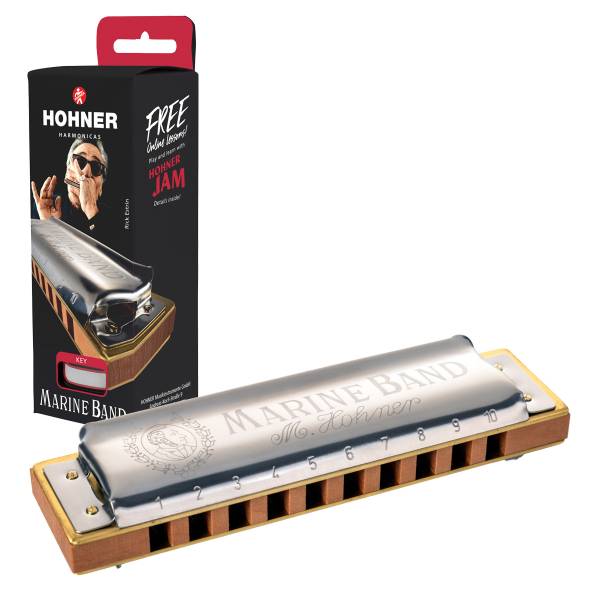 Silver and pearwood Hohner Marine Band diatonic harmonica positioned in front of its black retail display box featuring a portrait of musician Rick Estrin.