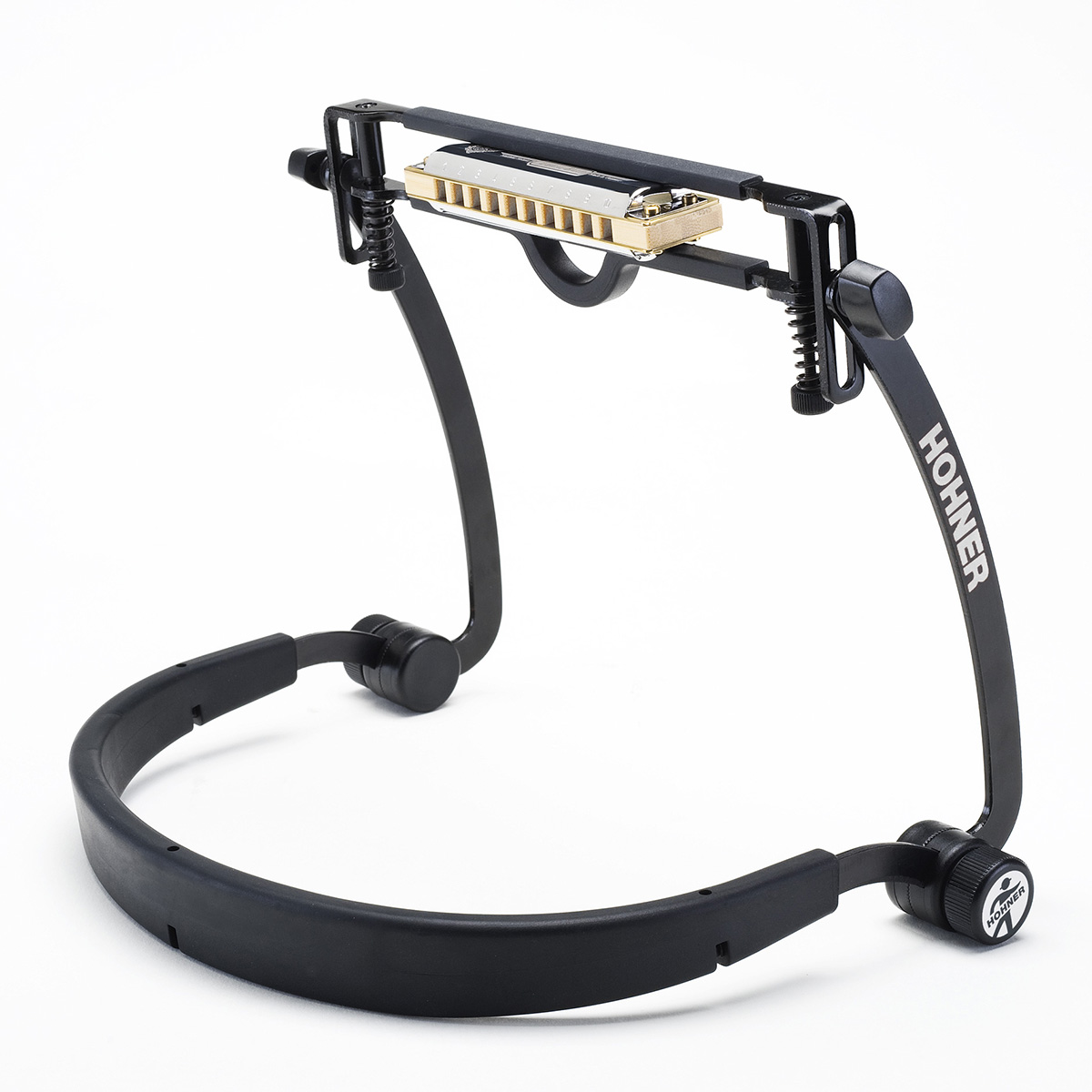 A black Hohner FlexRack harmonica neck holder supporting a gold and silver harmonica in its adjustable clamp.