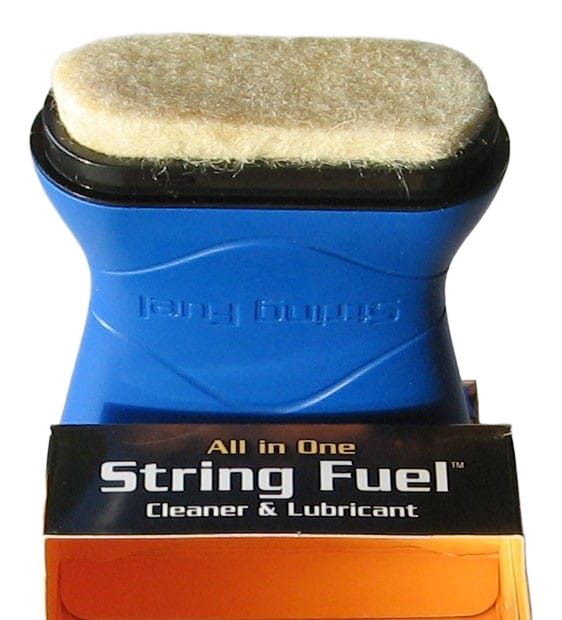 Music Nomad String Fuel applicator pad resting on top of its black and orange retail box.
