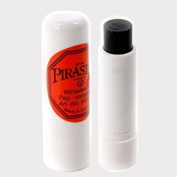 A white cylindrical plastic tube of Pirastro peg compound with a black twist-up paste inside, featuring an orange and red label reading Wirbelseife and Art.-No. 9041.