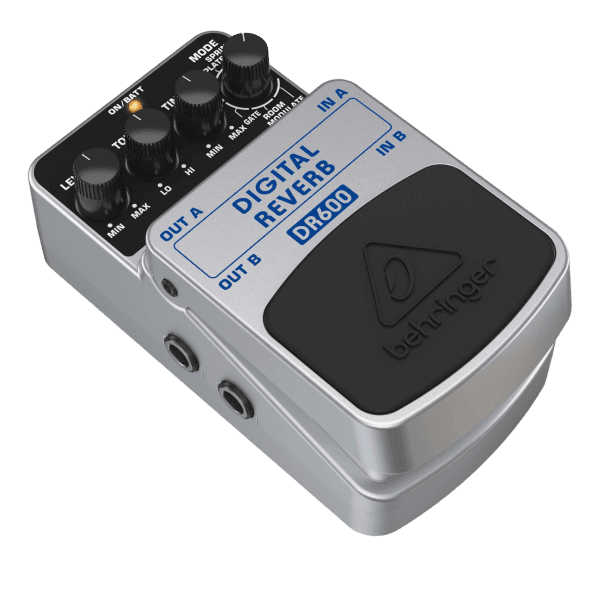 A top-down view of a white Behringer DR600 Digital Reverb effects pedal with four control knobs and a foot switch.