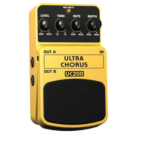 A yellow Behringer UC200 Ultra Chorus effects pedal viewed from above, showing its control layout and main footswitch.