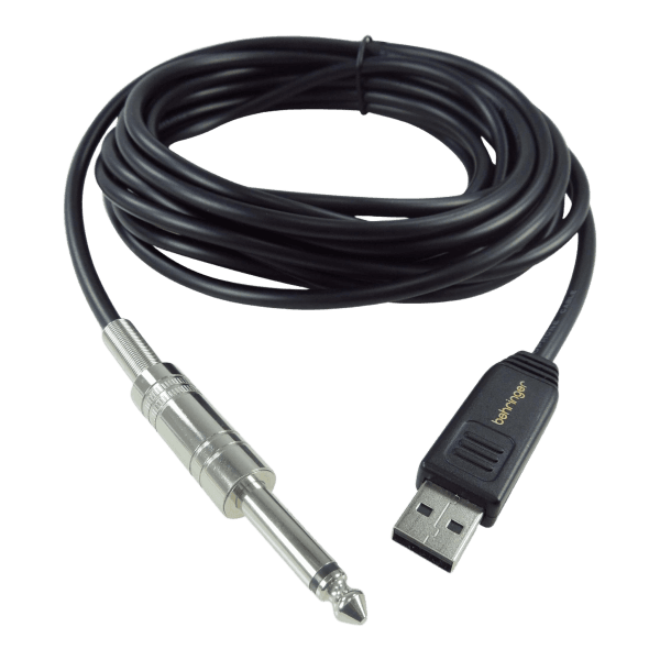 A coiled Behringer Guitar 2 USB cable featuring a quarter-inch instrument jack on one end and a USB connector on the other.