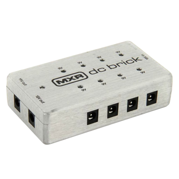 Silver rectangular MXR DC Brick power supply unit showing multiple power ports on the side and small LEDs on top.