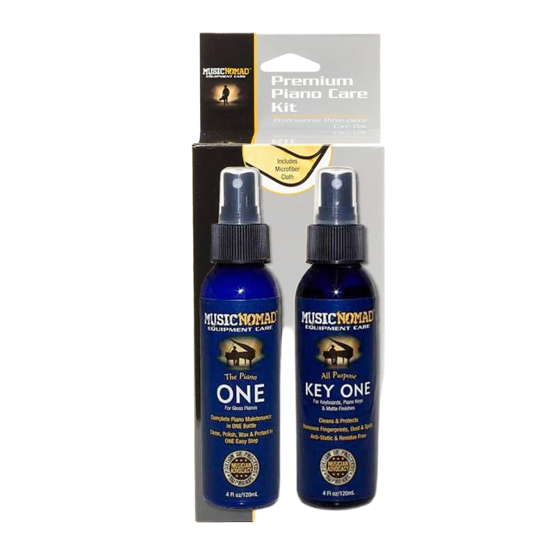 Music Nomad Premium Piano Care Kit retail display box holding two spray bottles, featuring printed text on the packaging that indicates an included microfiber cloth.