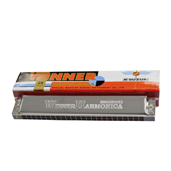 A silver tremolo harmonica with a black comb and 24 square holes, positioned in front of an elongated orange, white, and blue cardboard box.