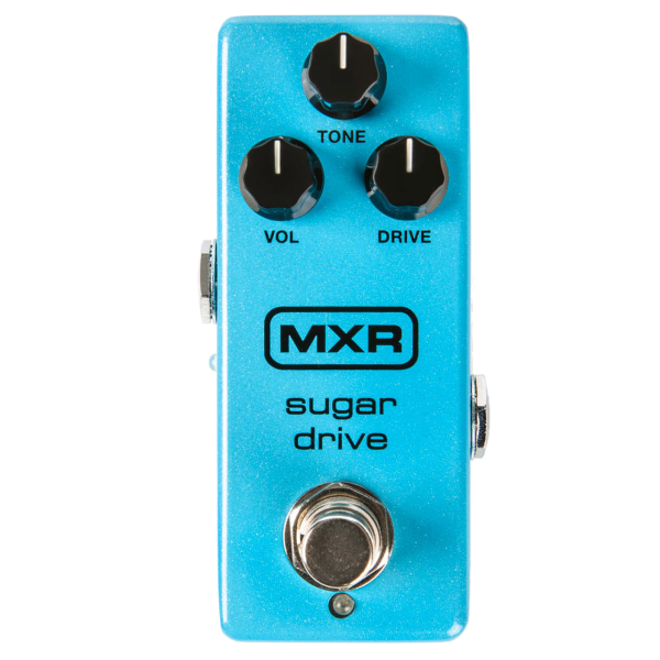 A light blue sparkle MXR Sugar Drive mini effects pedal with three black knobs labeled VOL, TONE, and DRIVE, and a silver footswitch.