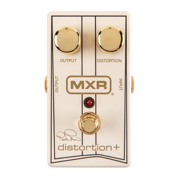 An off-white MXR Randy Rhoads signature Distortion+ pedal featuring black pinstripe detailing, two gold control knobs for output and distortion, a gold footswitch, and the artist's printed signature.