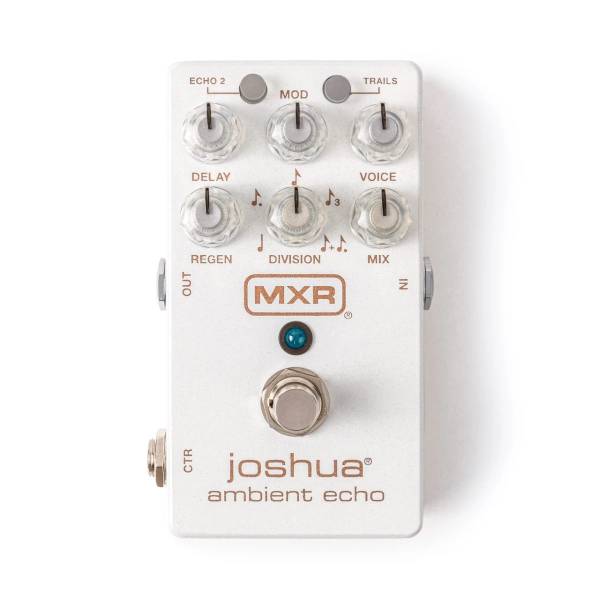 : A Birds-eye view from the top down of the white and gold joshua ambient echo guitar pedal, featuring six control knobs for delay modification, voicing, regeneration, division of time signature and overall mix of sound. The Joshua ambient echo and MXR logo, along with all other mods are printed in shimmery gold atop the beautiful creamy white/ivory coloured stombox. In on the right and Out on the left, and control output option on the left of the main silver footswitch.